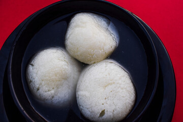 Traditional popular Indian sweet dish big size Rasgulla or rosogula , Bengali syrupy dessert sweets.