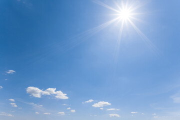 Naklejka na ściany i meble sparkle sun on a cloudy sky, natural summer sky background