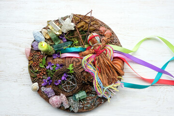 Wiccan altar for Beltane sabbath. spring pagan festive ritual. wheel of the year with ribbons,...