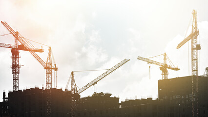 Fototapeta na wymiar Multi-storey building and high-rise cranes.
