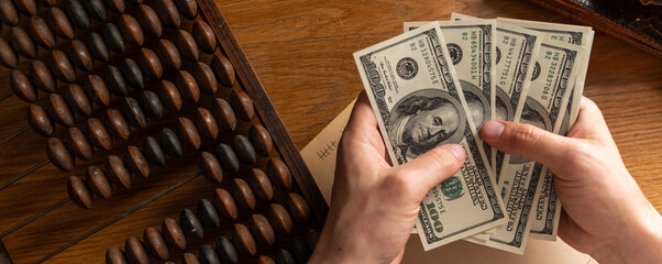 Business man counting money, saving money, and taking notes for the future And calculate income-expenses for the family, money-saving ideas and counting money