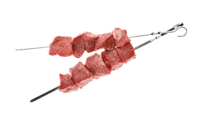 Metal skewers with raw meat on white background