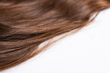 Bright brown hair on a white background close-up
