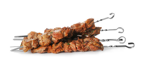 Metal skewers with delicious meat on white background