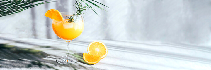 Banner with summer soft drink under palm leaf on gray concrete background. Rest, tourism, summer....