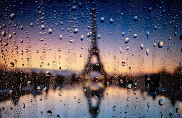 Rain raindrops on the window glass evening city lights macro photo. Bokeh backround.