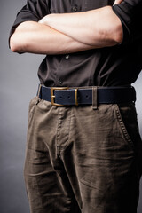 Black leather belt with ash buckle at men's waist
