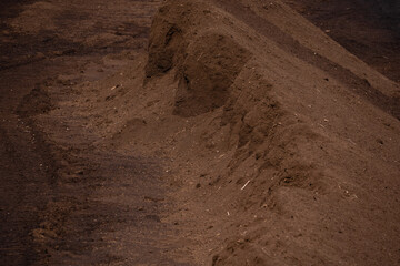 large brown peat piles can be seen in the peat extraction bog.