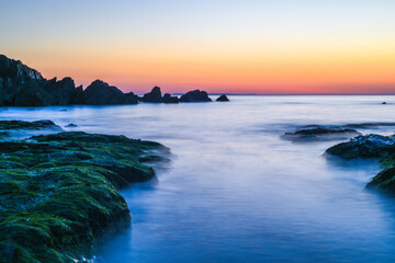 Beautiful calm sea and sunset scenery on the ocean as light reflects on the water