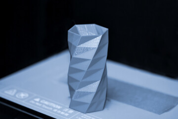 The object printed 3D printer on a blue and black background