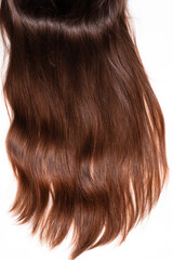 Naklejka premium Strand of dark brown hair on a white background