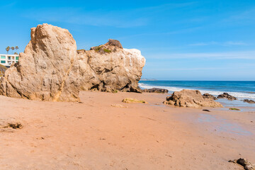 Matador beach and beautiful landscape with rocks and ocean against blue sky, California