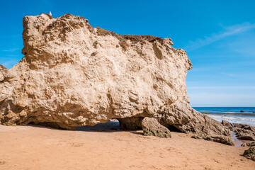 Matador beach and beautiful landscape with rocks and ocean against blue sky, California