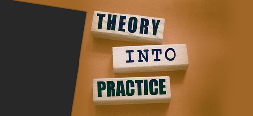 Theory into practice words written on wooden blocks. Education or business startup concept