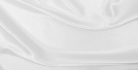 Obraz premium Smooth elegant white silk or satin luxury cloth texture as wedding background. Luxurious background design