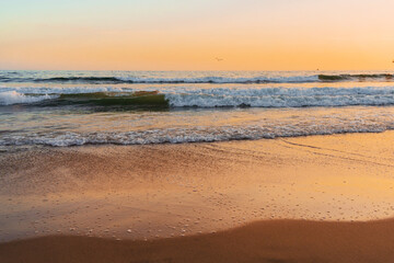 Fototapeta na wymiar Beautiful beach by the ocean during sunset
