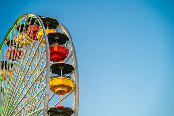 Santa Monica Ferris wheel against a blue sky - Powered by Adobe