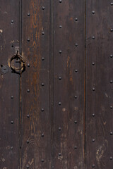 old dark wooden door with iron handles