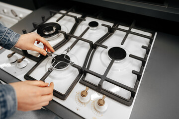 Close up of a woman hand checking new stove in a hypermarket