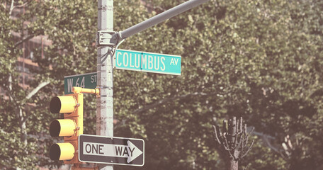 Traffic lights, Columbus Avenue and One Way street signs in New York City, selective focus, color toned picture, USA.