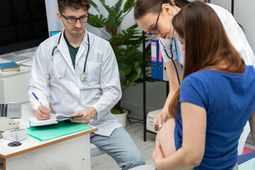 Your doctor auscultates the abdomen of a pregnant patient with a stethoscope. The attending...