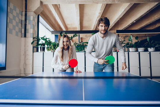 Young People, Man And Woman Playing Table Tennis