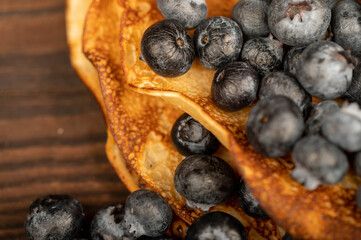 Fresh blueberries and traditional Russian pancakes. Shrovetide week of the end of winter.