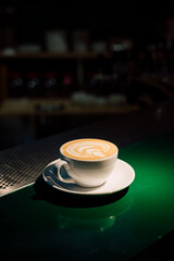 cup of capuchino on the green table