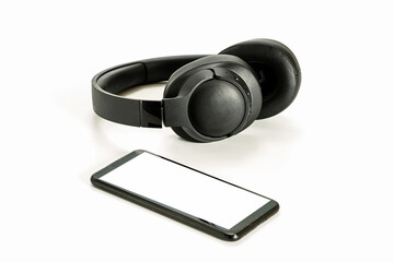 headphones with Bluetooth technology on white background, with black phone paired for music lovers