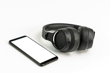 headphones with Bluetooth technology on white background, with black phone paired for music lovers