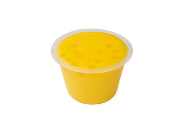 Yellow mango pudding, a close up of sweet mango mousse dessert in plastic cup isolated on white background.