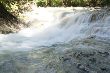 Fast water flow and waterfall in the Zhane riverbed in the North Caucasus