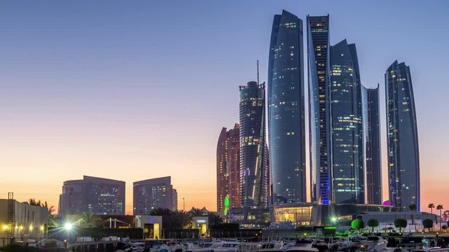 Al Bateen marina Abu Dhabi day to night timelapse with modern skyscrapers on background