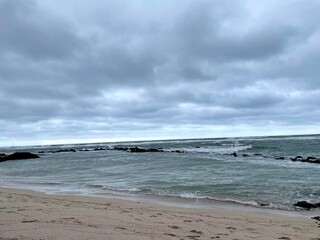 Sea waves lash line impact rock on the beach