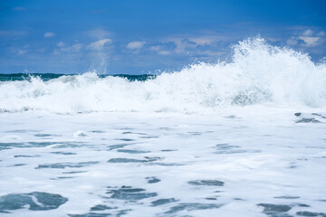A wave crashes on the horizon in the distance at Blowing Rocks in Florida.