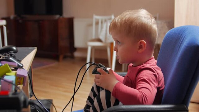 Excitable boy playing video game profile home in quarantine