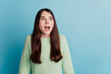 Photo of astonished dreamy woman open mouth look empty space on turquoise background