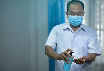 Portrait of an old man, 60 years old,Using alcohol antiseptic ge