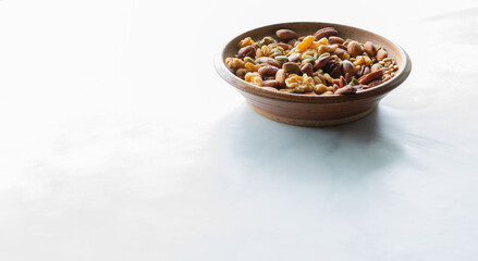 A bowl of trail mix brightly lit from behind.