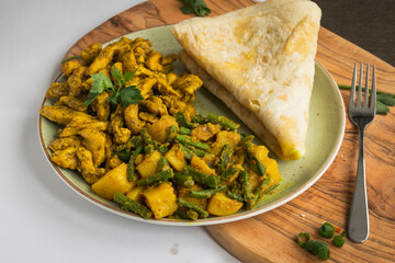 Indian-surinamese spicy food lunch and dinner roti chicken curry meal 