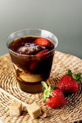 Glass of Homemade Cold Brew Coffee to Drink for Breakfast Summer Beverage with Ice Cubes Green Background Vertical