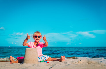 cute happy girl play with sand on beach