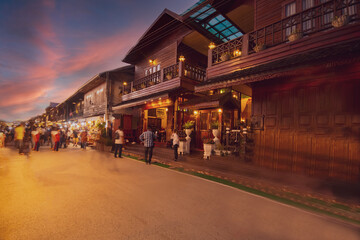 Blurred walking Loei Chiang Khan walking street and night market,Thailand people in street market at twilight with bokeh , Chinag Khan , Thailand_.jpg
