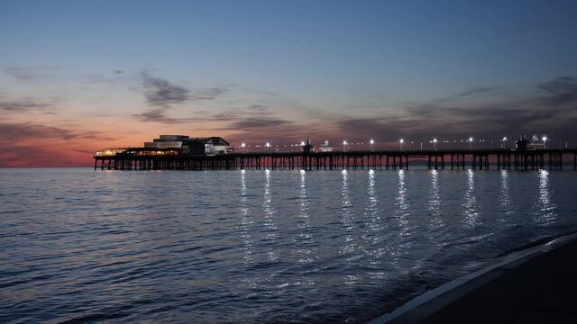 4K: Blackpool North Pier, England, UK at dusk. A closer shot with reflections in the sea. Stock Video Clip Footage