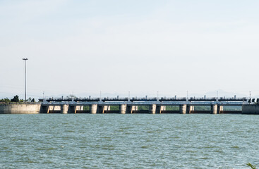 The many large gates of the service spillway on the reservoir dam.