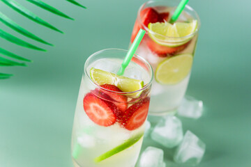 Glass of Tasty and Cold Strawberry and Lime Lemonade Summer Cold Drink Green Background Horizontal