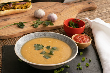 Dahl soup with yellow lentils on a table, lunch or dinning