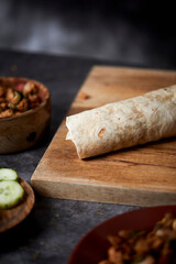 chicken and vegetables durum or burrito on a table - obrazy, fototapety, plakaty