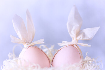 Easter creative. Two eggs with rabbit ears in a nest, decoration idea