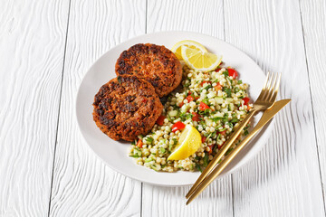 harissa lamb burger with couscous salad and lemon